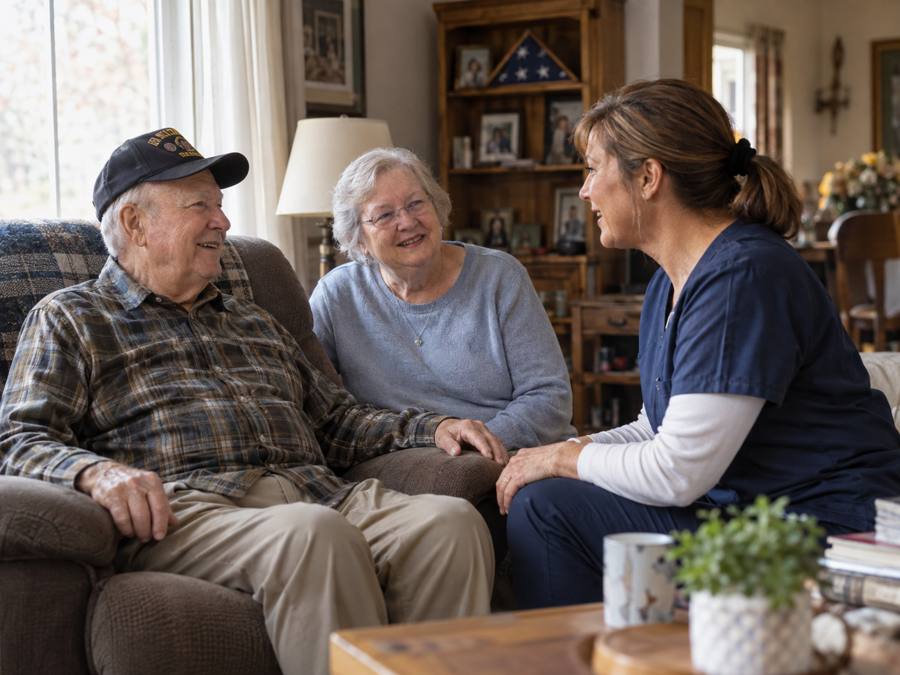 A caregiver visiting an older couple in their living room